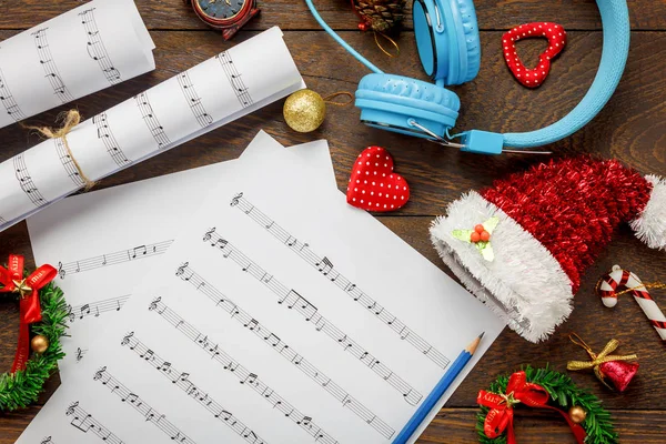 Top view Christmas music note paper  with Christmas decoration.