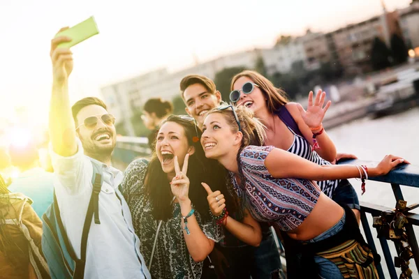 Happy young people taking selfies