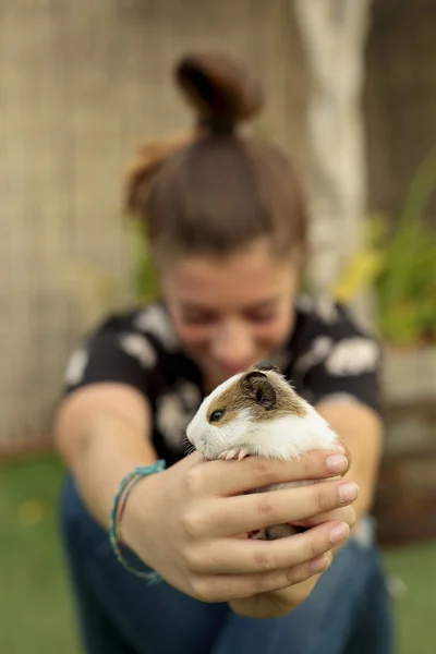 Girl happy with your Guinea pig in the hands.