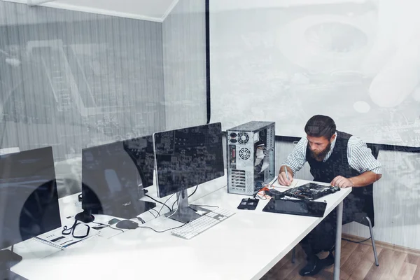 Computer repairing at office, double exposure