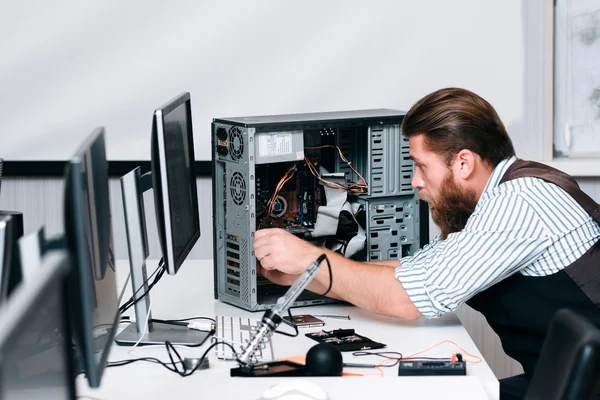Repairman fixing components in computer unit