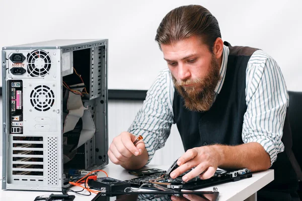 Bearded repairman fix computer circuit