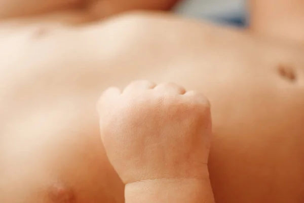 Little fist of newborn baby close-up