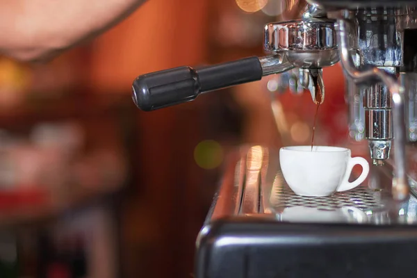 Espresso machine making coffee, golden espresso flowing. Coffee