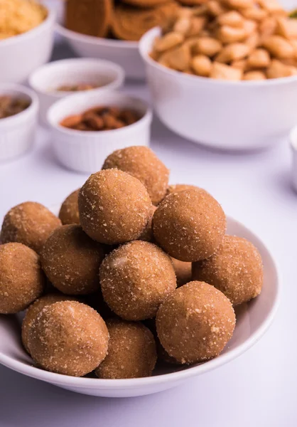 Home made tasty Diwali food or Diwali snacks or Diwali sweets like rava laddu, chakli, sev,shankar pale and chivda or chiwada with dry fruits in white bowls, favourite indian diwali recipe