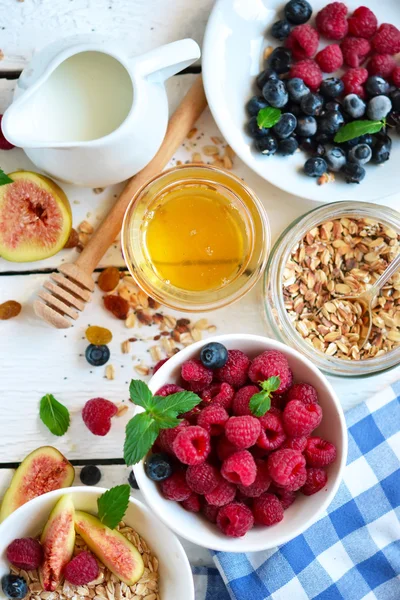 Good morning - granola with honey, berries and fruits.