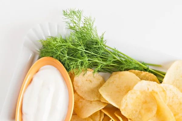 Chips with sour cream and dill sauce isolated