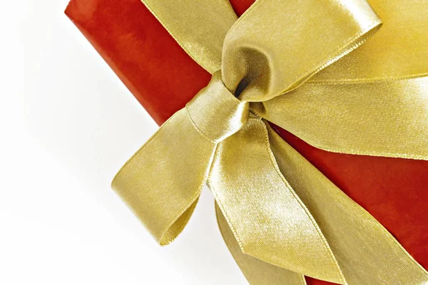 Gift red box with gold ribbon and bow isolated