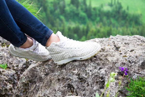 Close Up, shoes walking an lying hiker front of a mountainous la