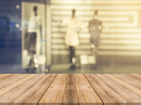 Wooden board empty table blurred background. Perspective brown wood over blur in department store - can be used for display or montage your products.Mock up for display of product.