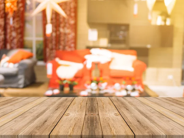 Wooden board empty table top on of blurred background. Perspective brown wood table over blur christmas tree and fireplace background, can be used mock up for montage products display or design layout