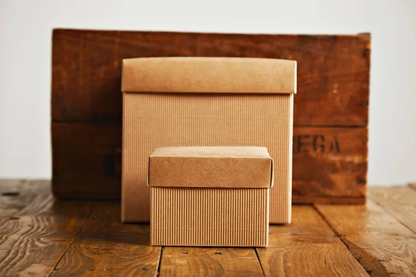 Blank corrugated cardboard boxes with vintage wooden box
