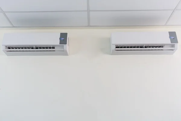 Air conditioner split type embed on wall of living room.