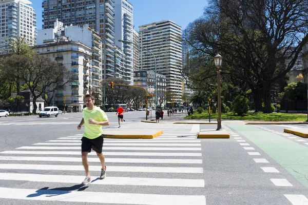People running in a street in the city of Buenos Aires, in Argentina