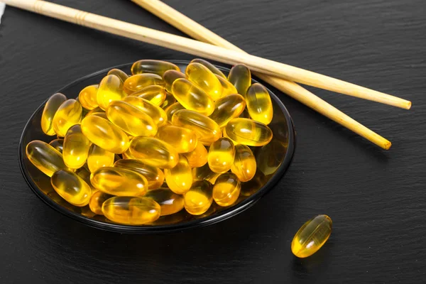 Fish oil supplements in soft gel capsule, healthy product concep