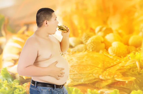 Fat man eating hamburger on sea food background