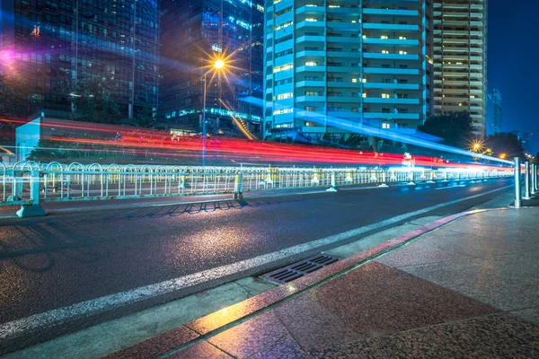 Blurred traffic light trails on road at night in China.