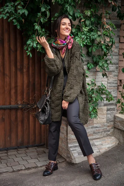 Streetstyle woman wearing colorful knitted coat