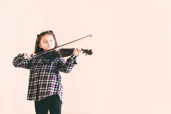 Mixed race female kid playing violin, child education or music concept, with copy space