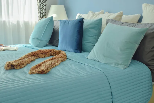 Scarf on bed in blue color scheme bedding