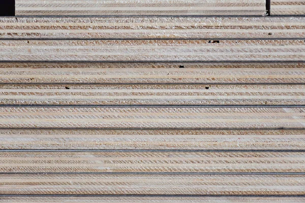 Stack of industrial plywood in construction site for background