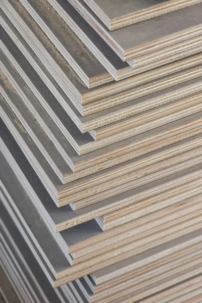 Stack of industrial plywood in construction site for background