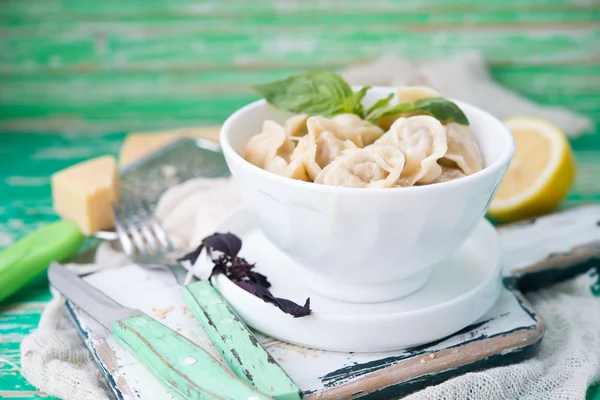 Plate of boiled pelmeni with cheese