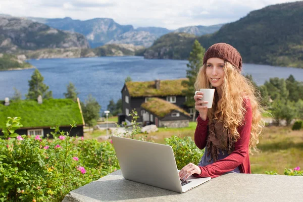 Freelance girl working on laptop in nature and beautiful landscapes