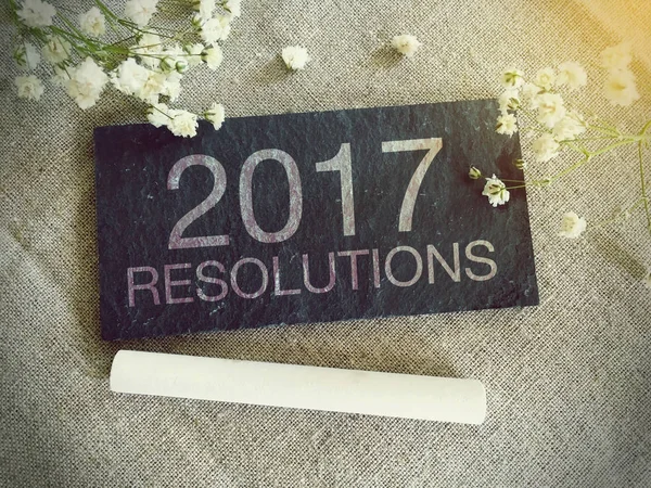 Blackboard for your text and flowers with words 2017 Resolutions