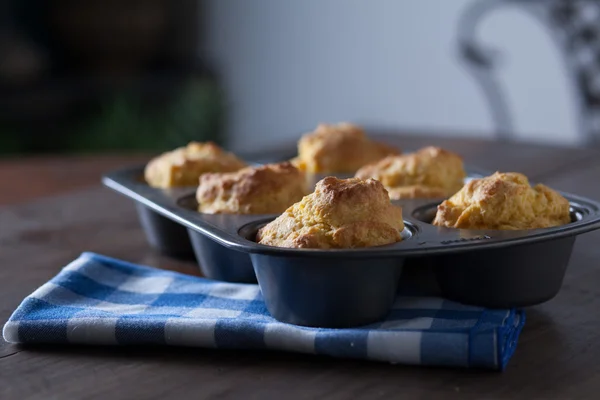 Corn Bread Muffins In Muffin Pan On Country Distressed Wood Table