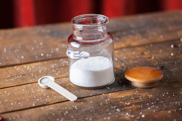 White Coarse Ground Salt On Wooden Table Background