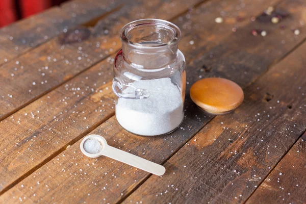 White Coarse Ground Salt On Wooden Table Background With Serving Spoon