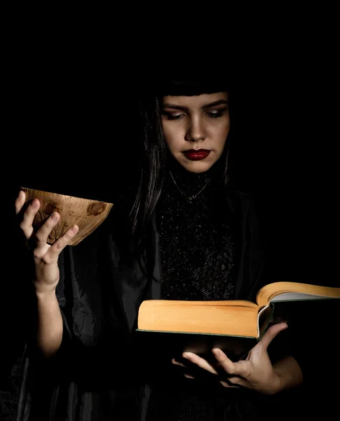 Beautiful young witch with a book of spells