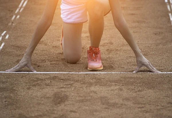 Runners feet on starting blocks in a athletic running track