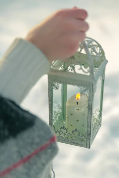 Closeup of hand holding beautiful vintage Christmas lantern