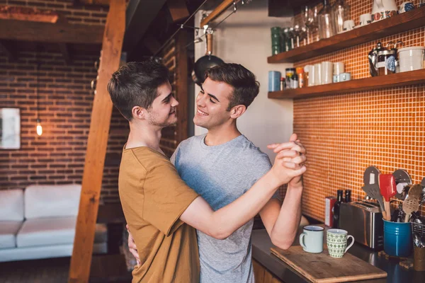 Gay couple dancing arm in arm together