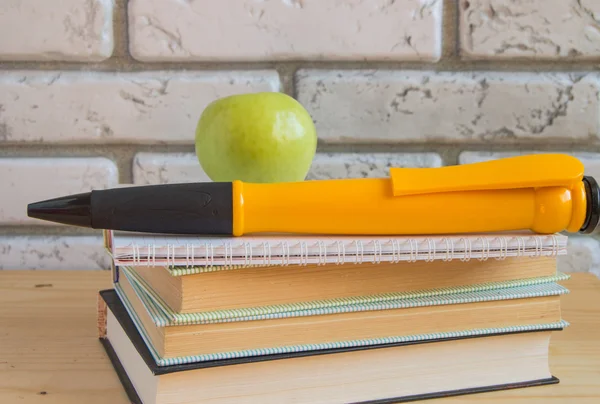 Apple large souvenir pen on books and notebooks, concept study