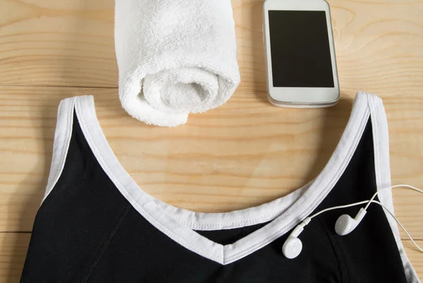 The concept of fitness and sport. Towel, mobile, T-shirt, headphones