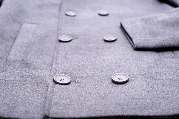 Special buttons on the gray coat