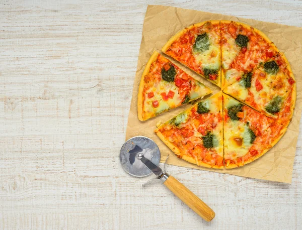 Sliced Baked Pizza with Pizza-cutter and Copy Space