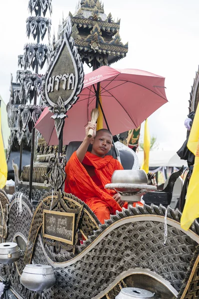 Suratthani, Thailand - October 20, 2016: Buddhist monk sitting on ornamented carriers during Chak Phra Festival, held after the end of the three-month period of Buddhist Lent