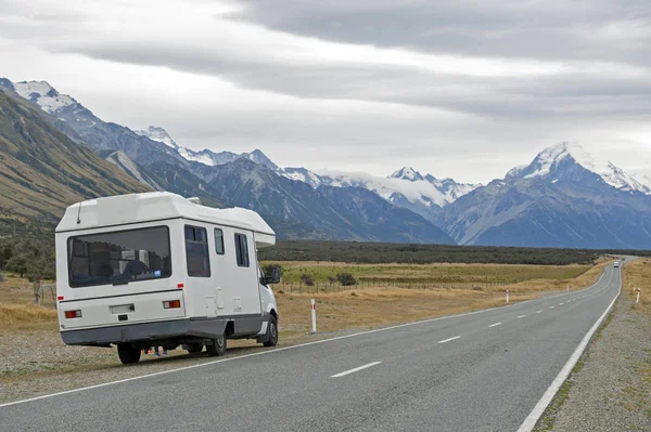 Mount Cook, New Zealand - February 2016: Motorhome on Mount Cook Road (State Highway 80) along the Tasman River leading to Aoraki / Mount Cook National Park and the village