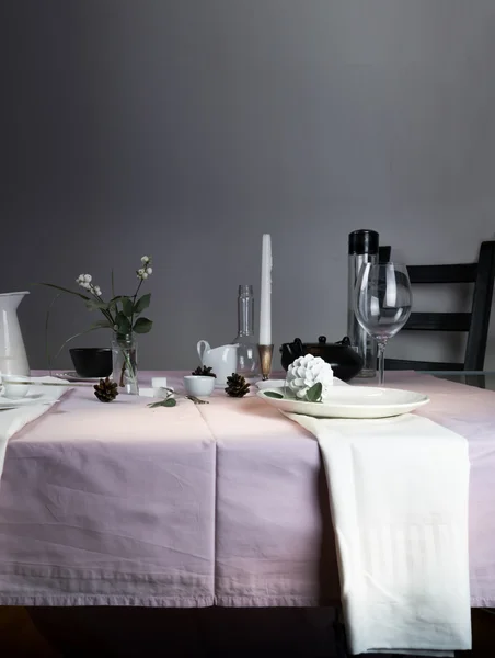 Elegant table setting. Christmas. romantic dinner - tablecloth, cutlery, candles, flowers, buds.