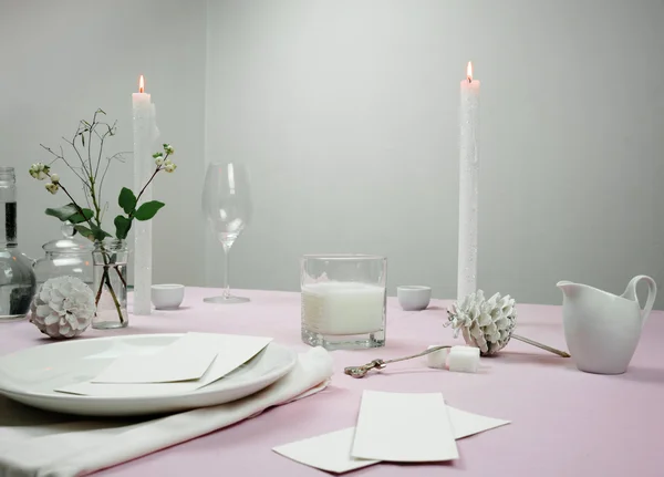 Elegant table setting. tablecloth, milk , flowers in a vase, candle