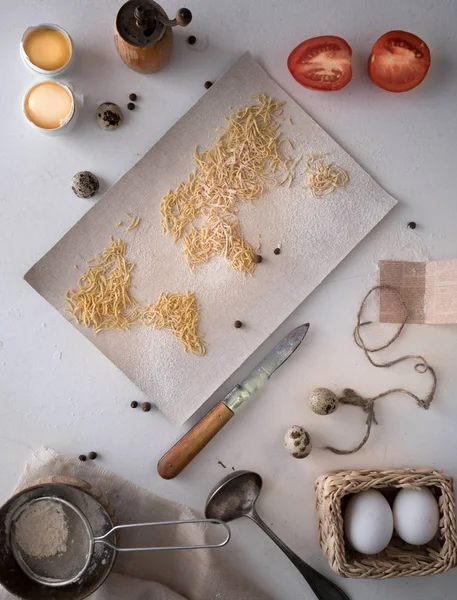 Map of the world  pasta on the canvas. flour sieve spices. food, top view