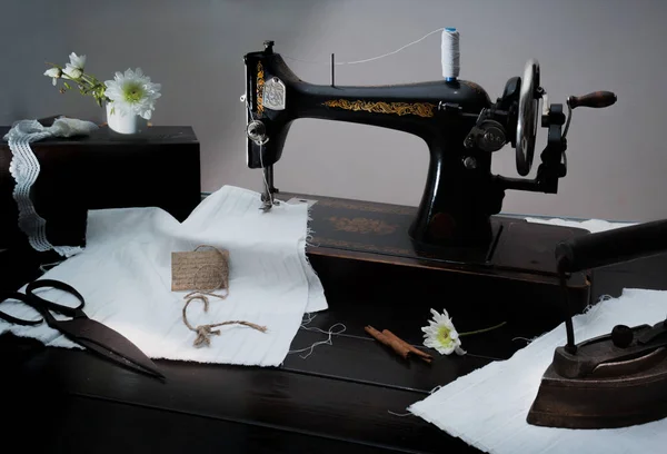 Classic retro style manual sewing machine ready for  work. The  is old  made of metal with floral patterns