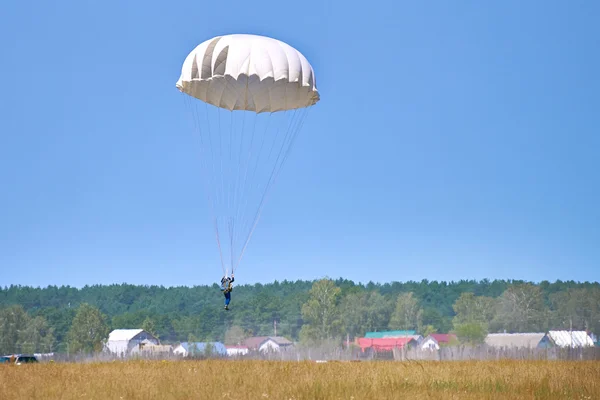 Parachutist landing in the field