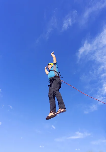 Jump rope from a high rock in the mountains.
