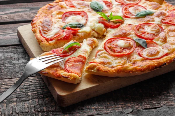 Fork on slice pizza. Close-up