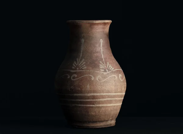 Old clay vase isolated on black. Path included